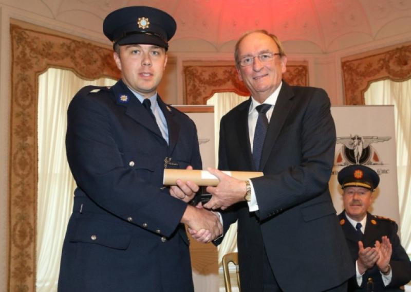 Garda Joseph Hayes receives a bronze medal from Sean Barrett TD at the National Bravery Awards. Picture: Maxwells