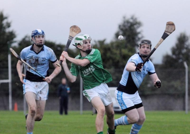 St Patricks' Jack Greenwood gets his clearance away despite the attentions of Pat McCarthy of Na Piarsaigh in the City Junior A Hurling Final played in Claughaun on Sunday.
