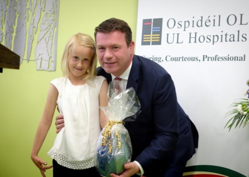 Tara Casey from Bruff in Co. Limerick who was the first patient in the new surgical day unit at Nenagh General Hospital makes apresentation to Minister Alan Kelly when he officially opened the Unit last Monday