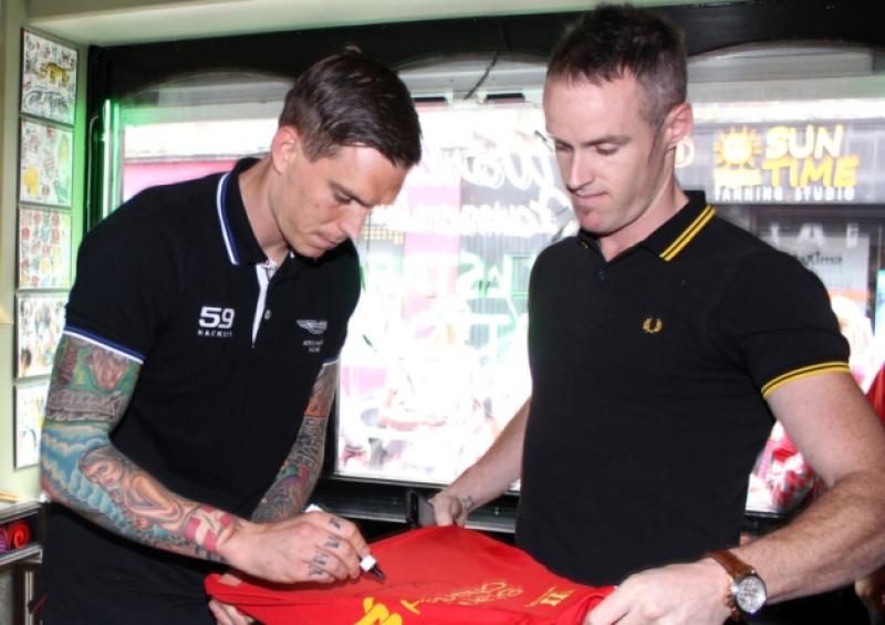 Star-struck: Daniel Agger signs a jersey for Liverpool fan Frank O'Regan in Allstar Ink on Wickham Street in Limerick. Picture: Adrian Butler