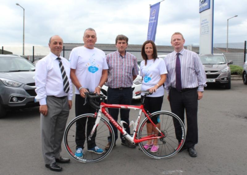 Founders of Ian's Trust, Oorla and John Cusack, with staff of Limerick Motor Centre at the launch of the To The Moon And Back cycle and run/walk, which will take place in Kilkee on August 16