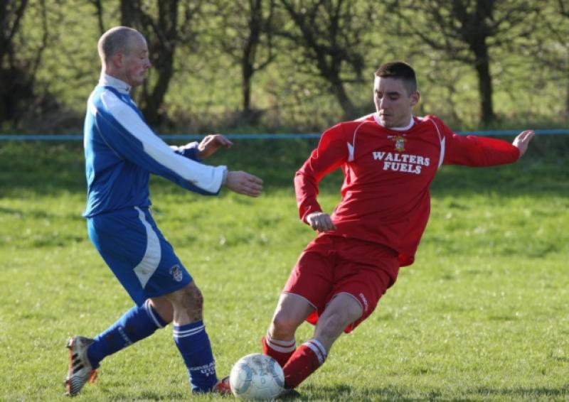Moyross United's Ger Cronin wins this challenge against Corbally in the LDMC Premier Division game on Sunday