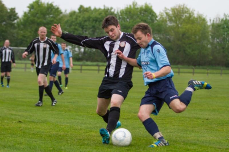 Newcastle's Daniel Power gets his foot in to block the clearance from Thomas Quilligan, Rathkeale