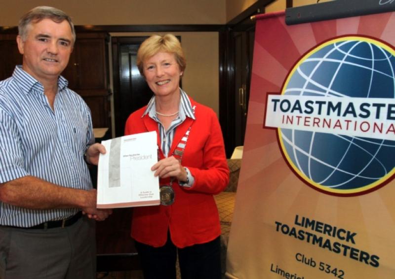 Outgoing  president Eamonn Finn with Eithne Gleeson, incoming president of Limerick Toastmasters, passing the Agenda on at the Castletroy Park Hotel [Picture: Brendan Gleeson]
