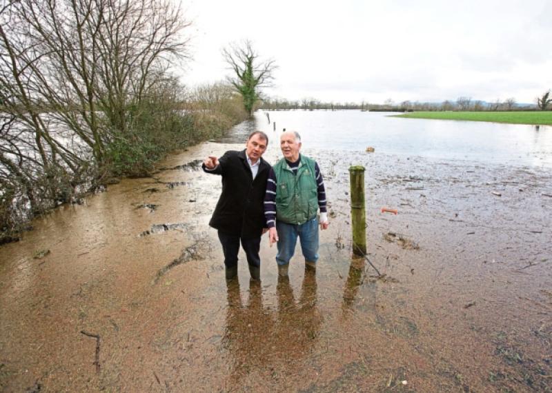 ICMSA President John Comer visiting the farm of Donal Hynes on his land in Lisnagry (Pic Sean Curtin Fusionshooters) and below, it has been an around-the-clock battle for Ger Enright to keep water out of his Mountshannon Road home  Picture: Michael Cowhey