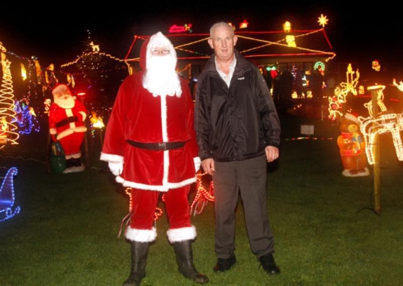 Santa with Tony Noonan who expects his house to feature on TV3 this Christmas. Picture: Dave Gaynor
