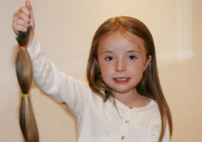 Ali Mai Murphy, who only turned six on May 1, above and below, shows just how long her hair was before it was cut off in Bellissimo by senior stylist Helen Irwin for the Rapunzel Foundation