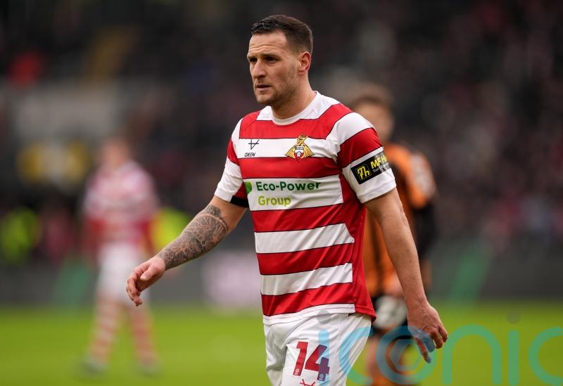 Doncaster clinch promotion after beating 10-man Bradford in incident-packed game