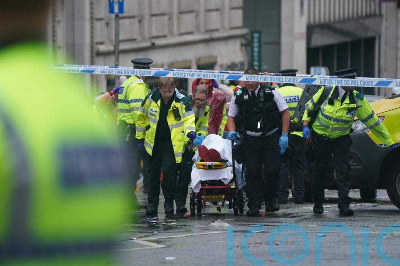 Man detained after car collides with pedestrians during Liverpool title parade