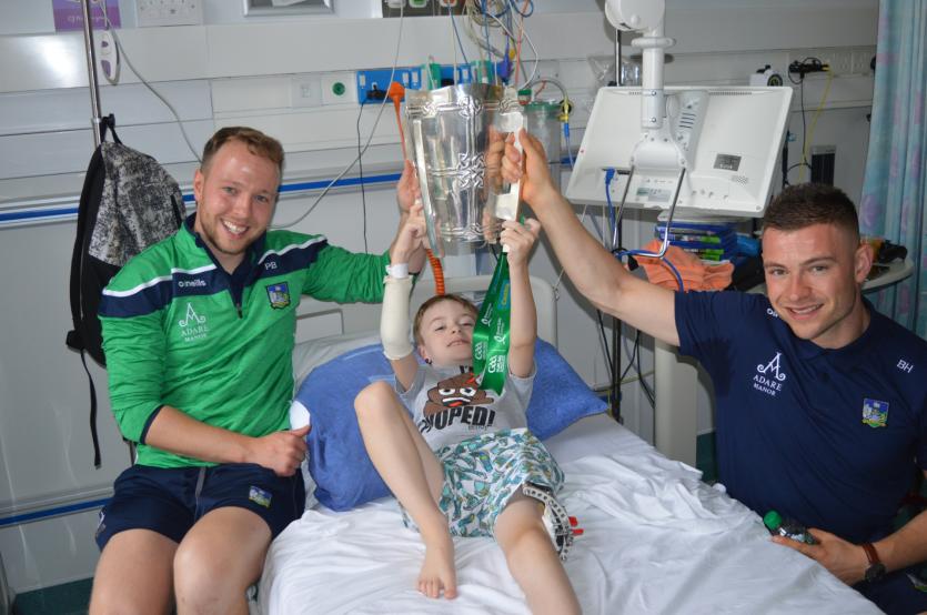 Paul Browne, Bruff and Barry Hennessy, Kilmallock with the Liam McCarthy Cup and  nine-year-old CJ Murphy from Kildare